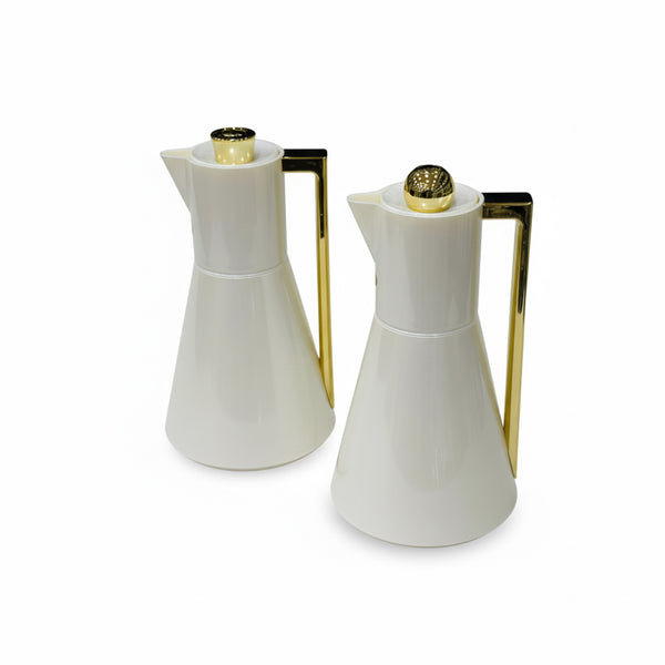 Two white ceramic pitchers with gold accents on a white background