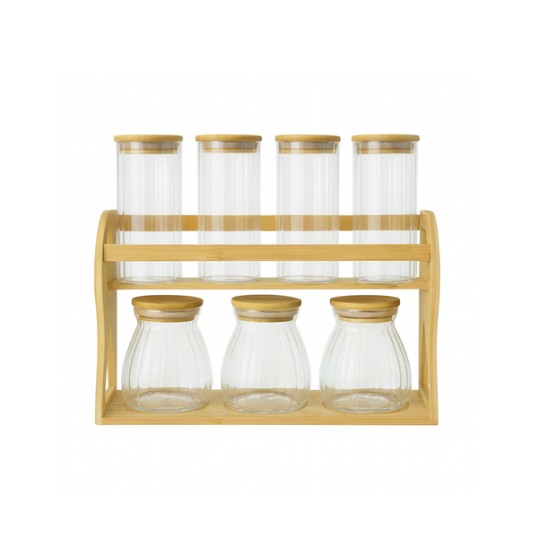 Set of glass jars with wooden lids on a wooden stand against a white background