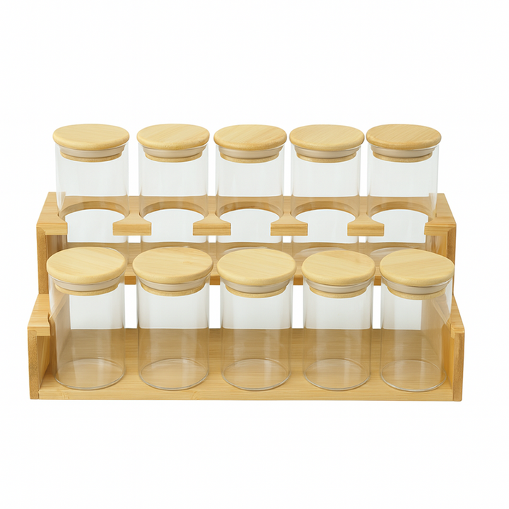 Set of glass jars with wooden lids in a wooden holder on a white background