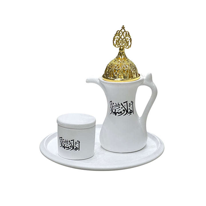 White ceramic pitcher and container with gold lid on a white background