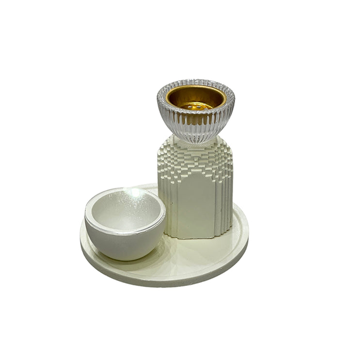 White candle holder with a textured base and gold accent on a white background