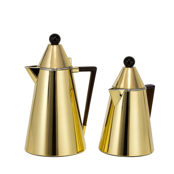 Two gold coffee pots with black knobs on a white background