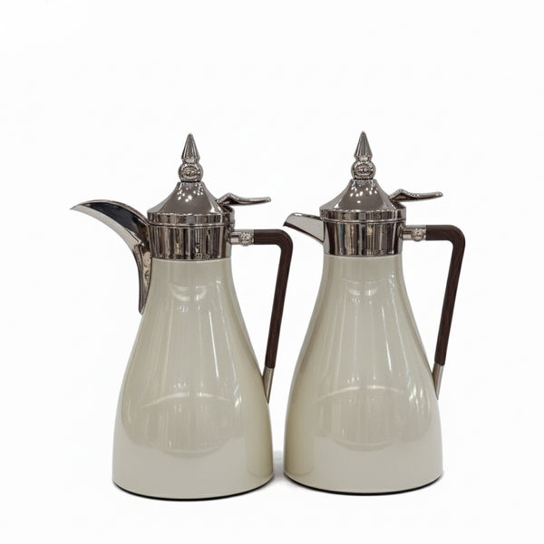 Two silver-trimmed glass carafes on a white background