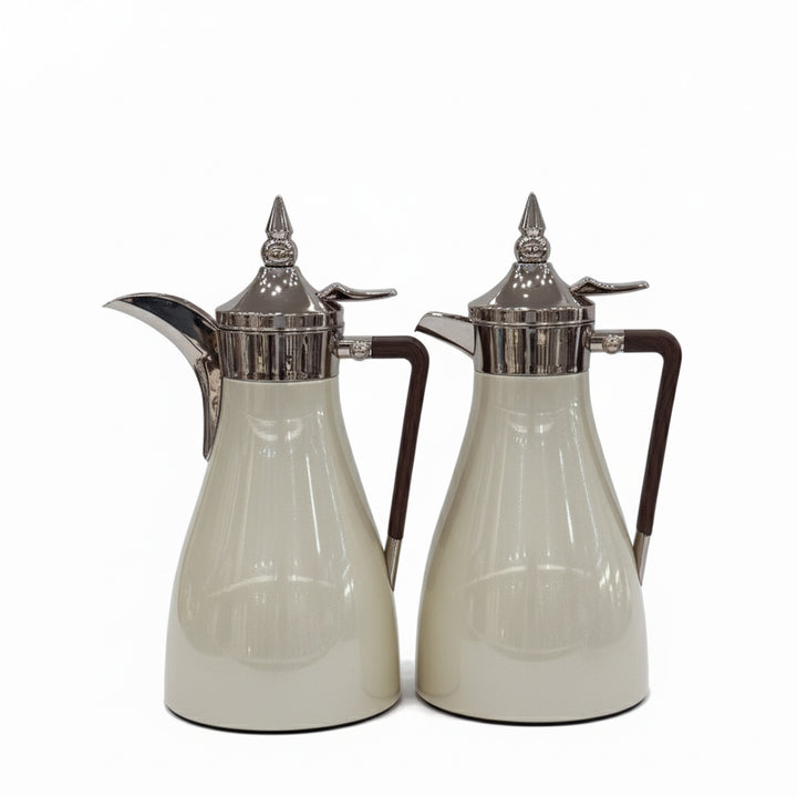 Two silver-trimmed glass carafes on a white background