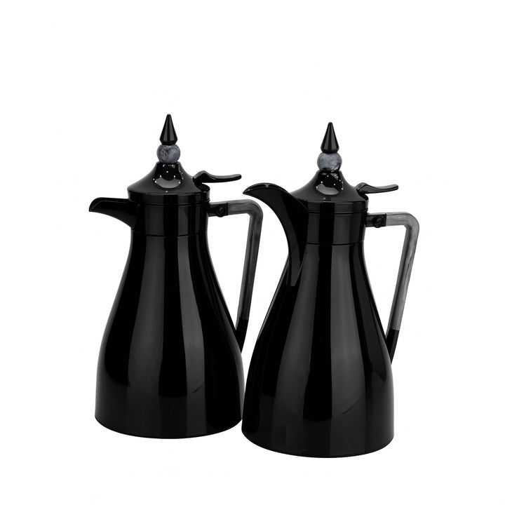 Two black coffee pots with spouts on a white background