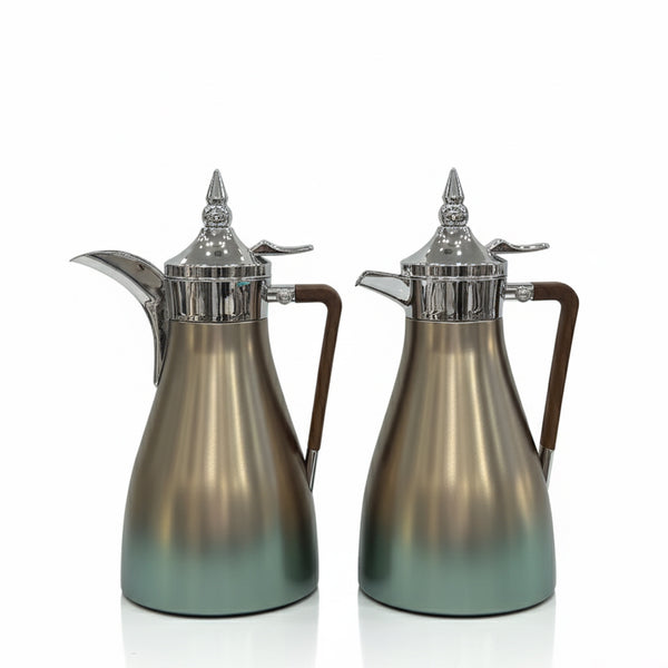 Two silver and bronze coffee pots on a white background