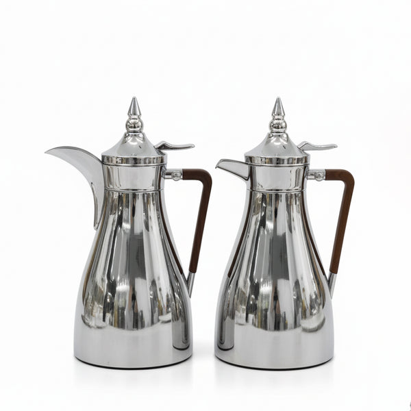 Two silver coffee pots with wooden handles on a white background