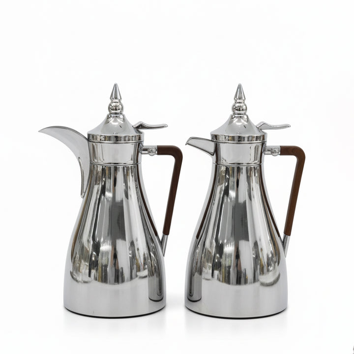 Two silver coffee pots with wooden handles on a white background