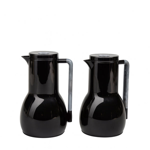 Two black ceramic pitchers on a white background