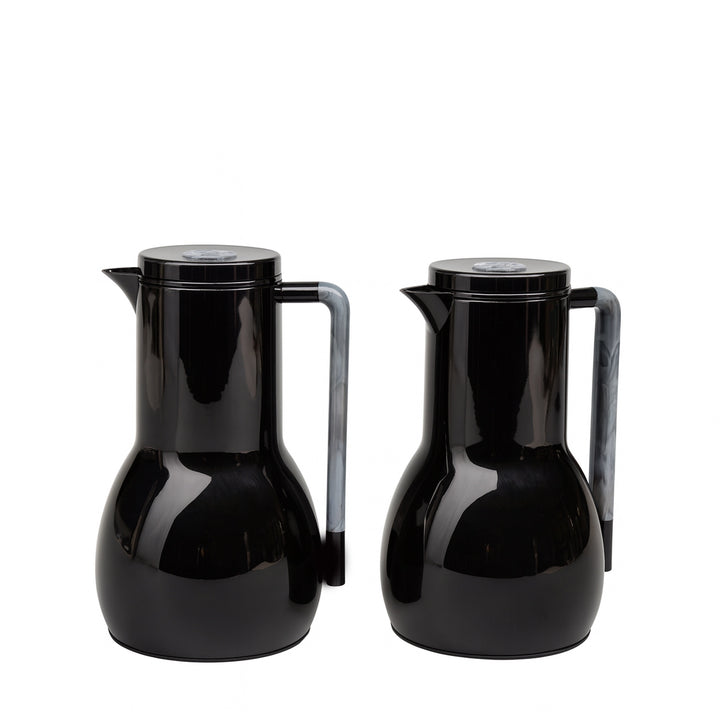 Two black ceramic pitchers on a white background