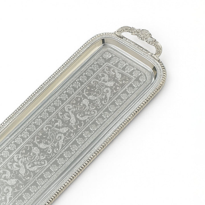 Decorative silver tray with intricate patterns on a white background