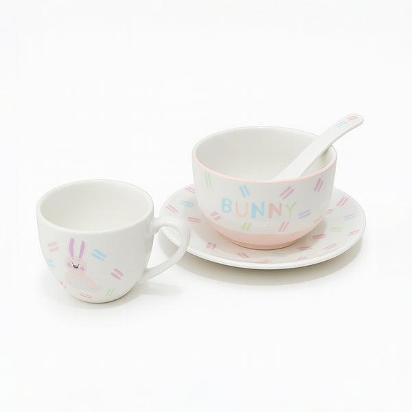 Ceramic cup, saucer, and spoon set with 'Bunny' text on a white background