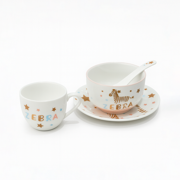 Ceramic cup, saucer, and spoon set with zebra design on a white background