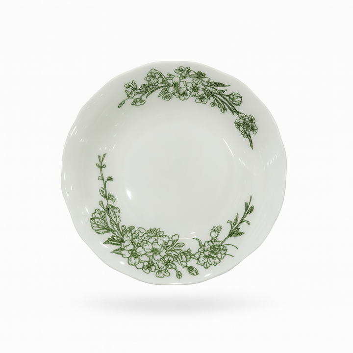 White plate with green floral patterns on a white background
