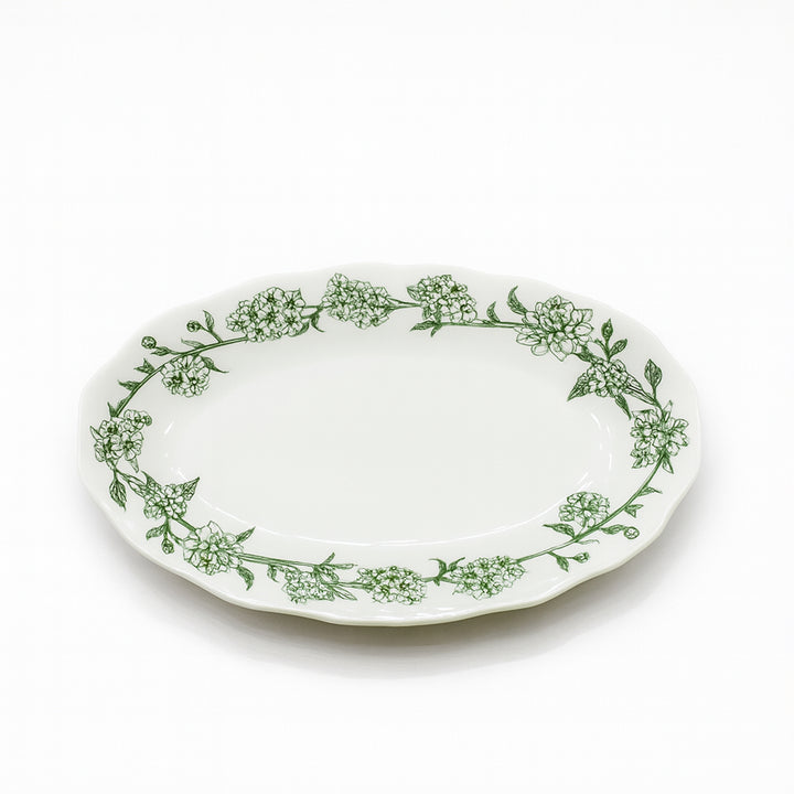 Oval plate with green floral pattern on a white background