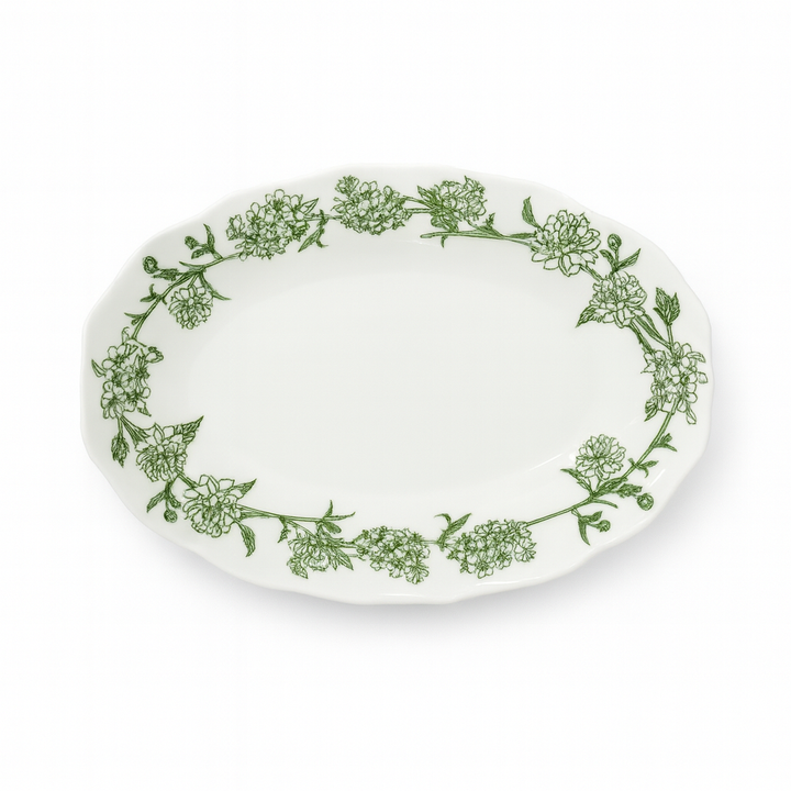 White plate with green floral pattern on a white background