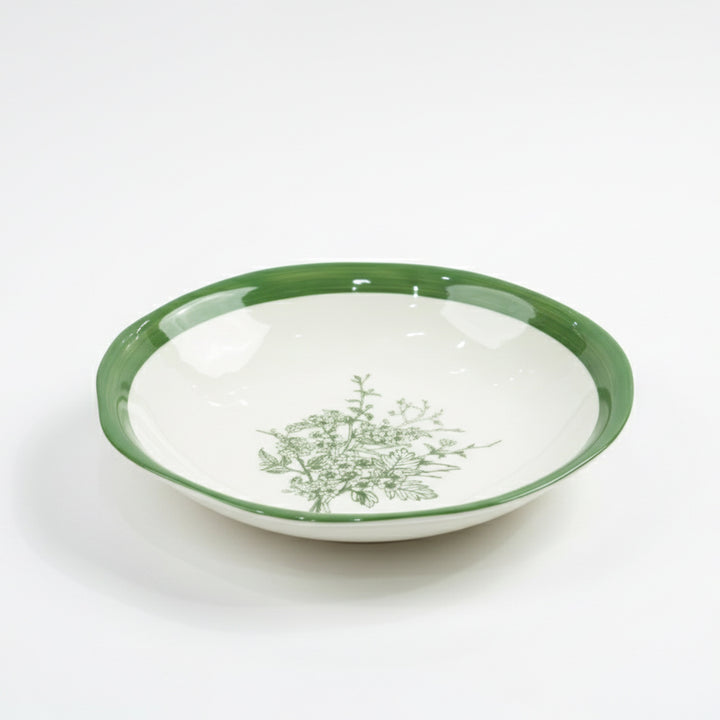 White bowl with green rim and floral pattern on a white background