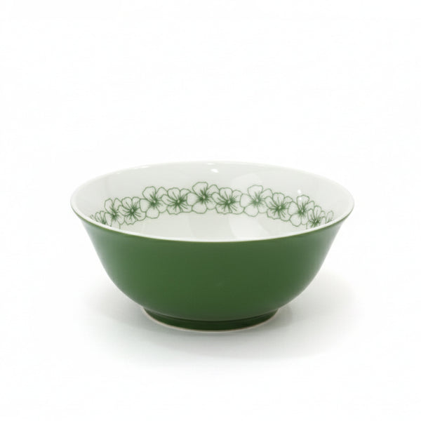 Green ceramic bowl with floral pattern on a white background