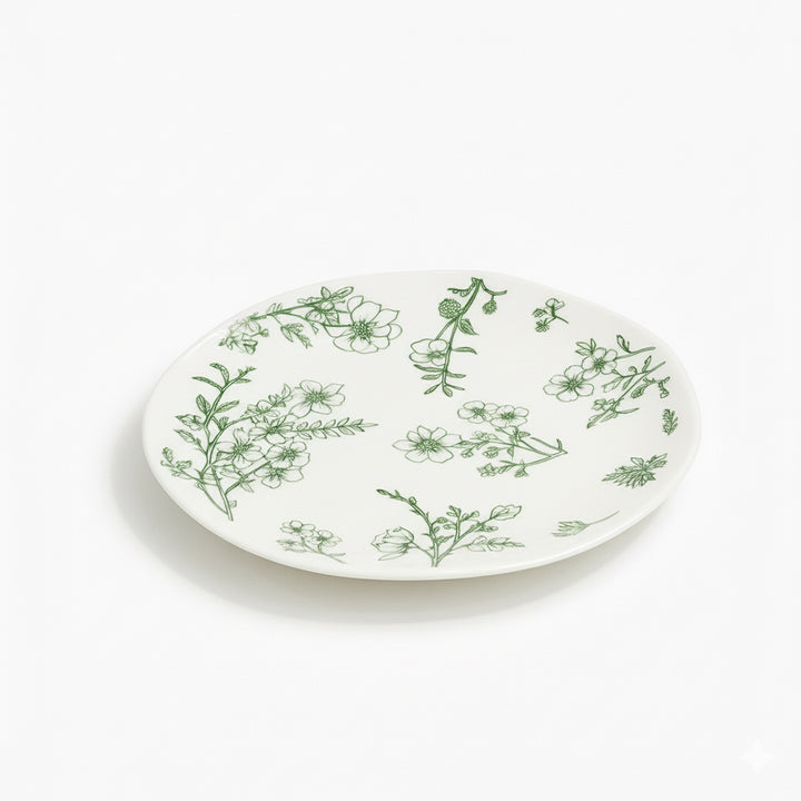 White plate with green floral patterns on a white background
