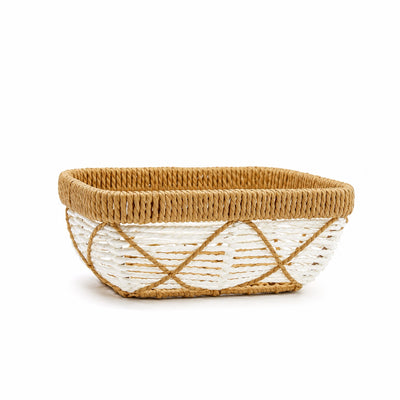 A rectangular woven basket with a natural tan seagrass body, a lighter beige braided rim, and a white woven lower section accented by diagonal tan crisscross lines, shown on a white background.