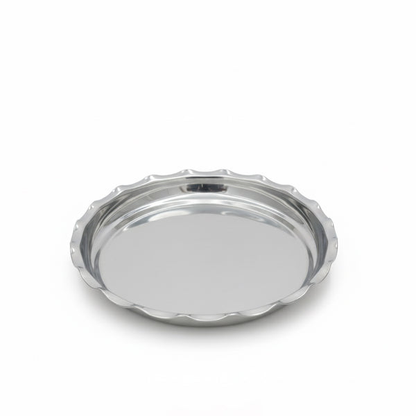 Silver round tray with scalloped edge on a white background