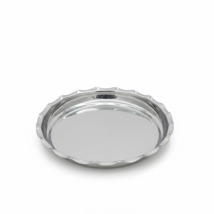 Silver round tray with scalloped edge on a white background