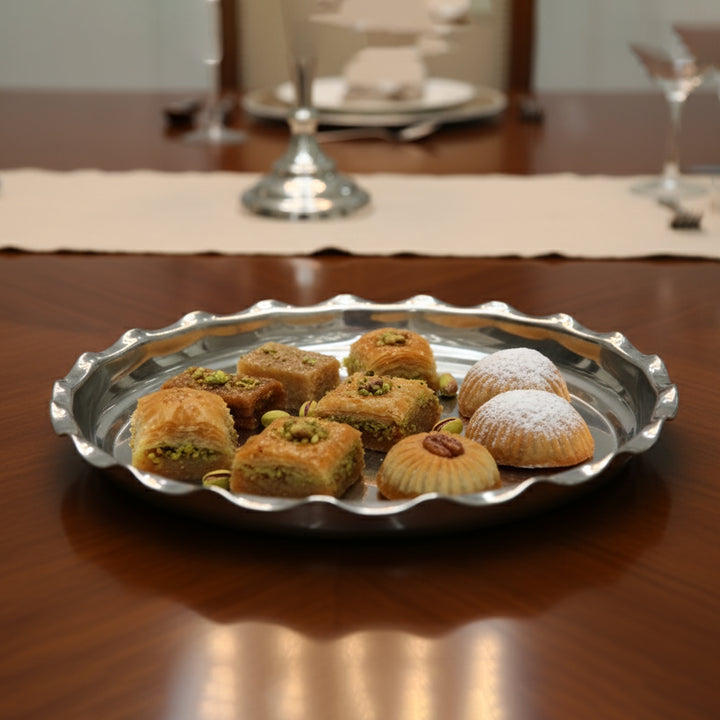 Silver tray with assorted pastries on a wooden table