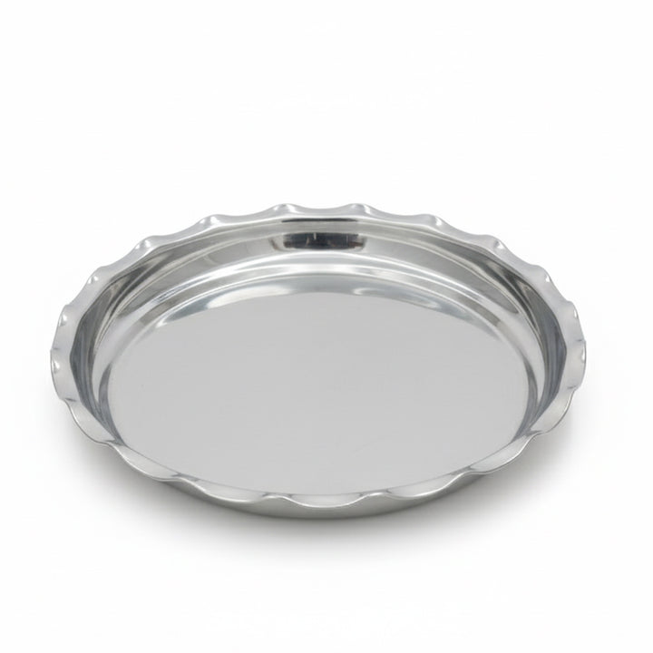 Silver tray with scalloped edge on a white background