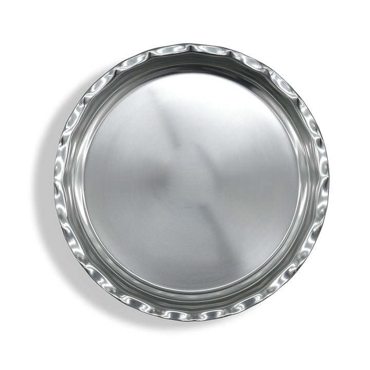 Silver round tray with decorative rim on a white background