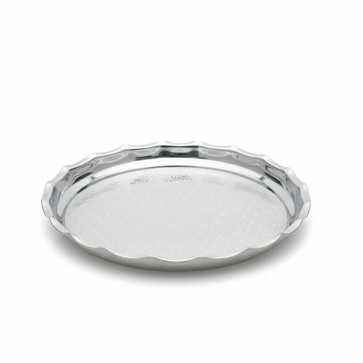 Silver tray with scalloped edge on a white background