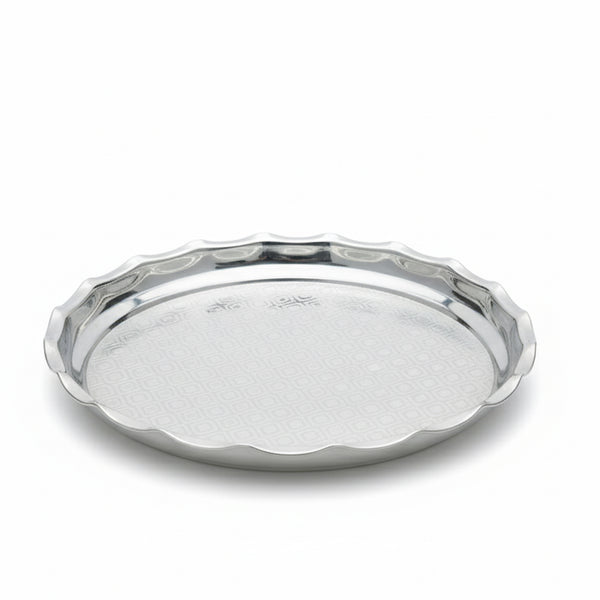 Silver tray with scalloped edge on a white background