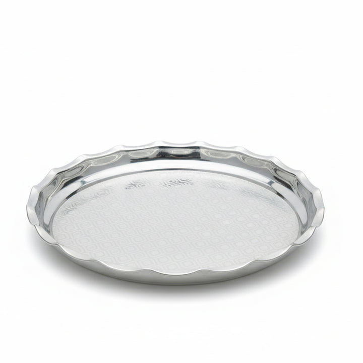 Silver tray with scalloped edge on a white background