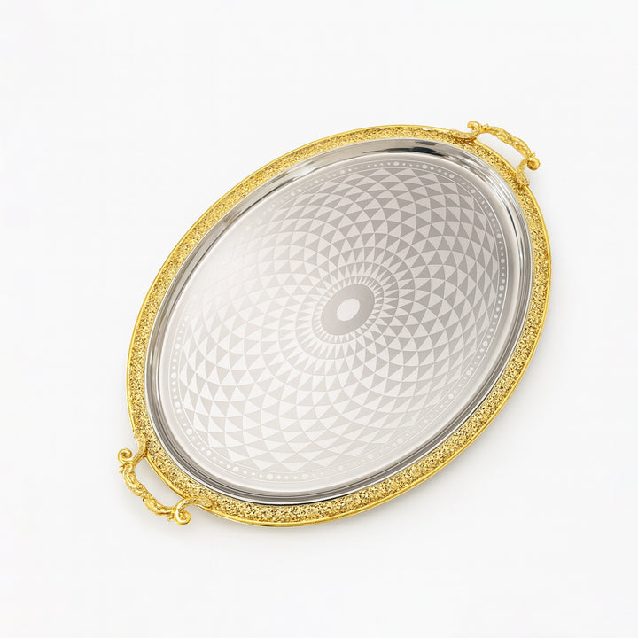 Decorative silver tray with gold rim on a white background