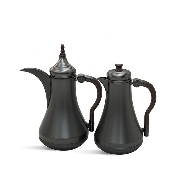 Two black ceramic teapots with silver accents on a white background