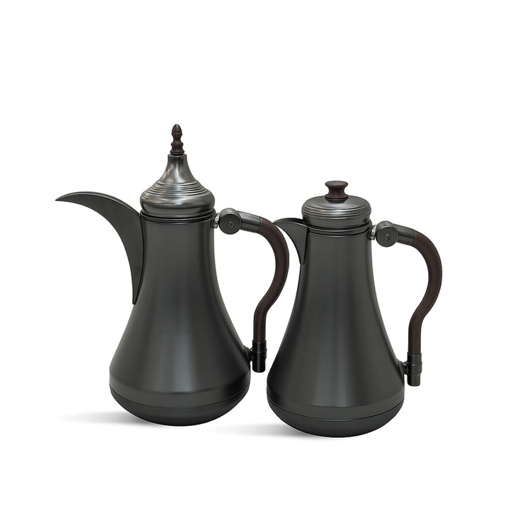 Two black ceramic teapots with silver accents on a white background