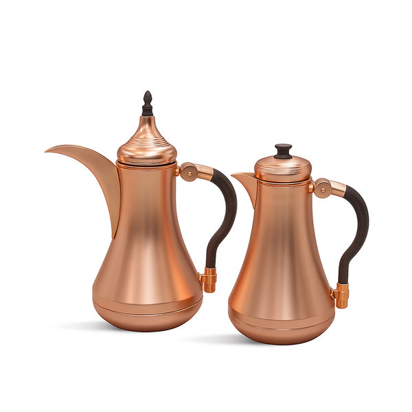 Two copper-colored coffee pots with black handles on a white background
