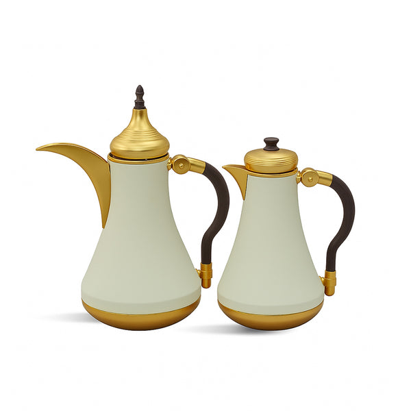 Two cream-colored teapots with gold accents on a white background