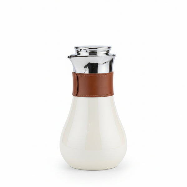 White carafe with brown leather strap and silver top on a white background