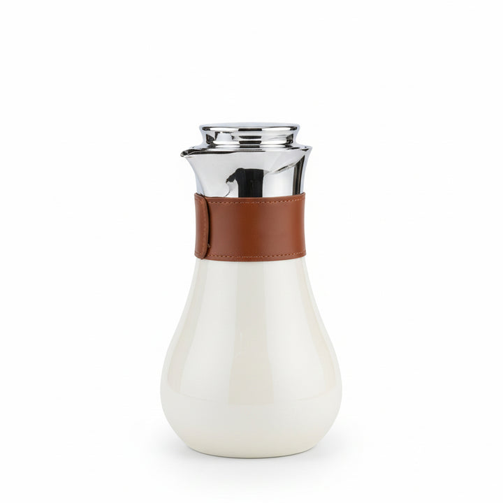 White carafe with brown leather strap and silver top on a white background