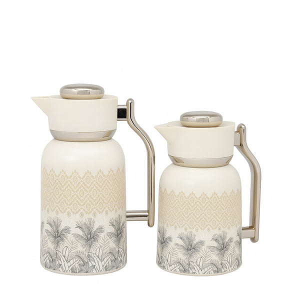 Two ceramic pitchers with decorative patterns on a white background