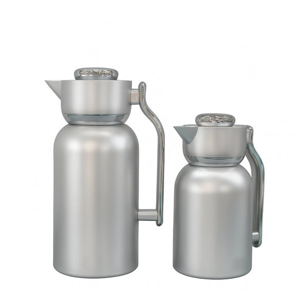 Two stainless steel carafes on a white background