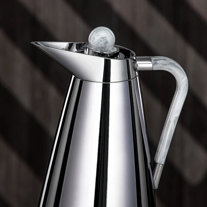 Silver coffee pot with marble handle on a dark background
