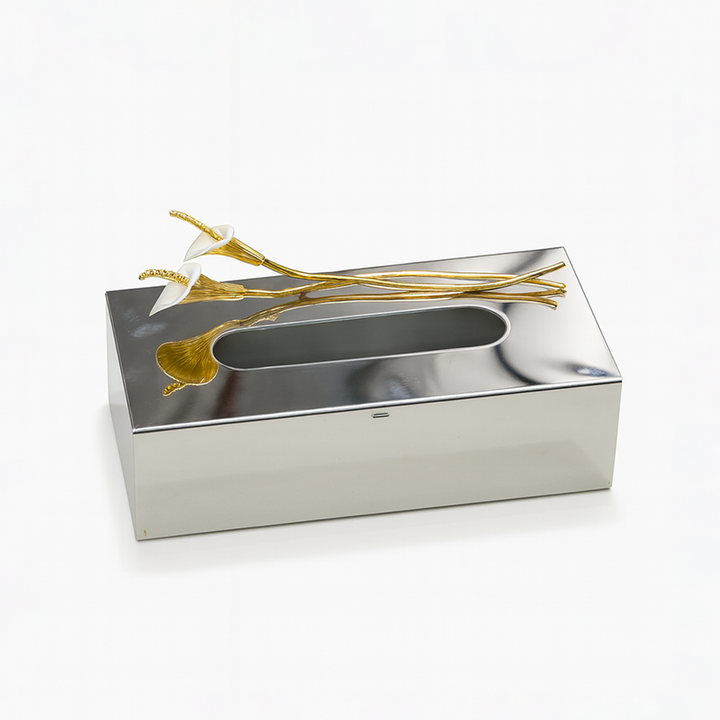 Silver tissue box with gold accents on a white background