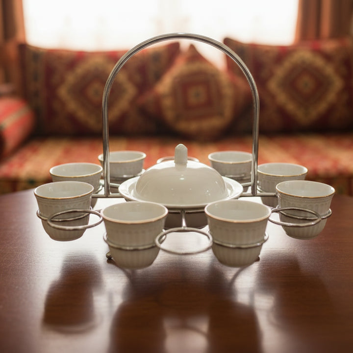 Tea set with a teapot and cups on a wooden table with a blurred background