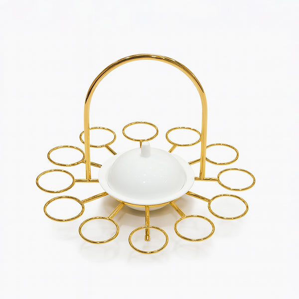 Gold decorative stand with a white bowl on a white background