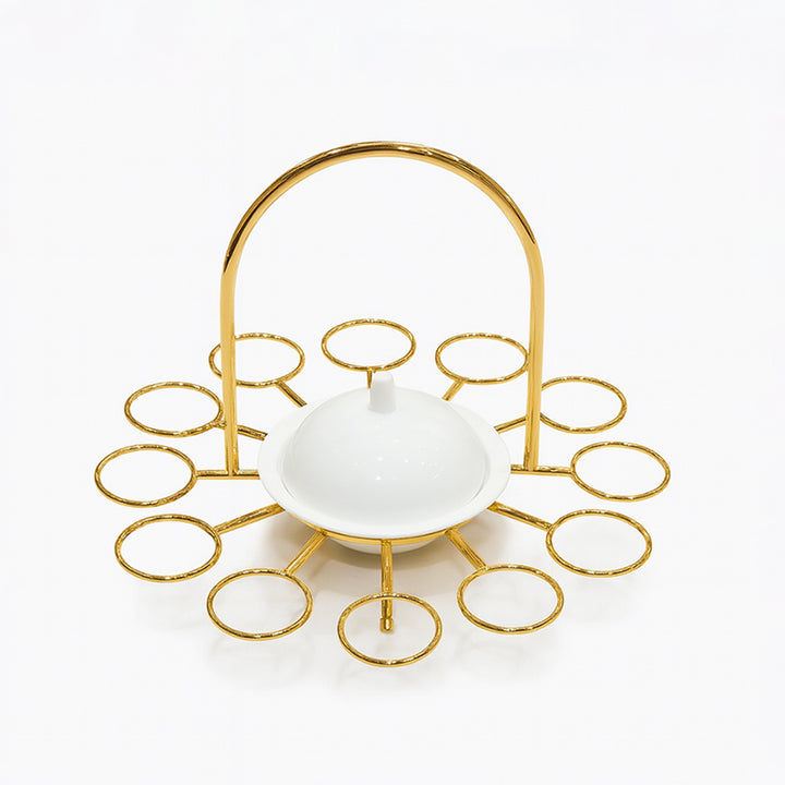 Gold decorative stand with a white bowl on a white background