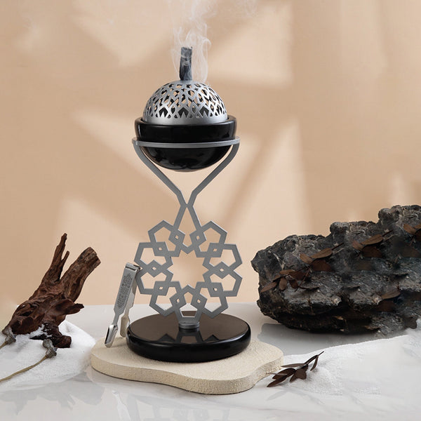 Decorative incense burner with smoke on a neutral background
