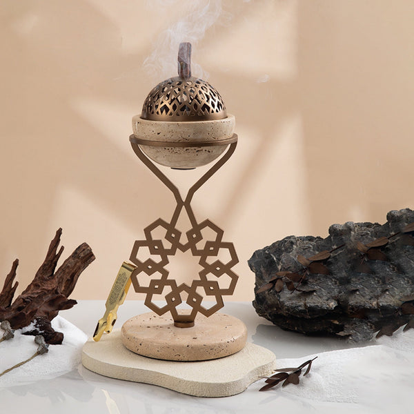 Decorative incense burner with smoke on a neutral background