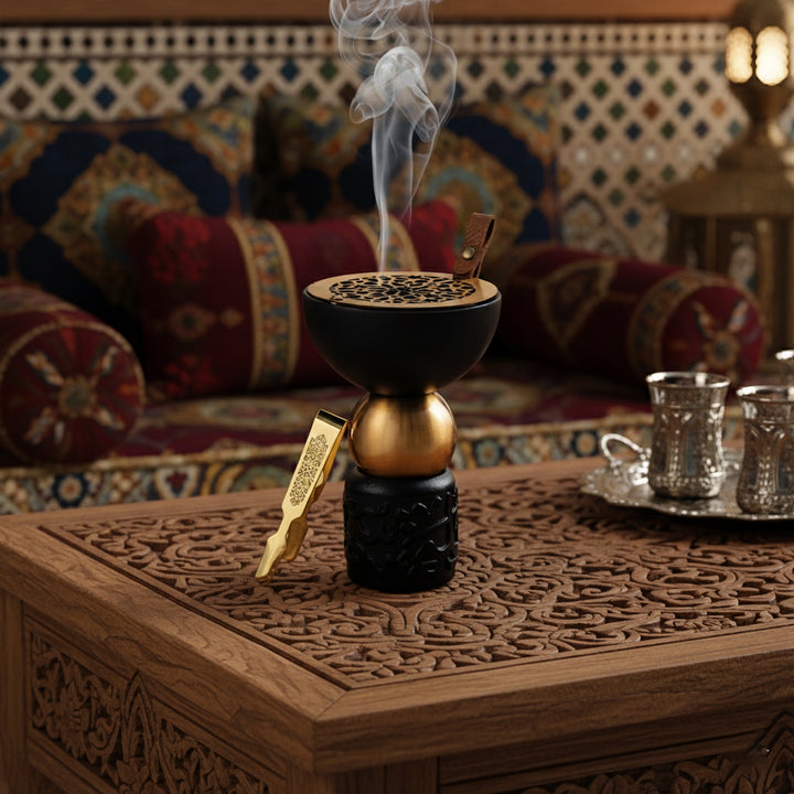 Decorative incense burner with smoke on a wooden table with a colorful patterned sofa in the background.