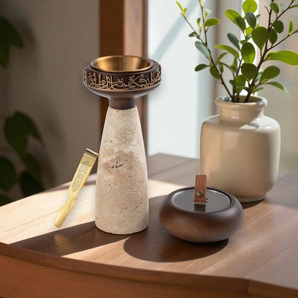 Decorative items including a tall ceramic vase with a bronze top, a smaller round vase, and a potted plant on a wooden surface.